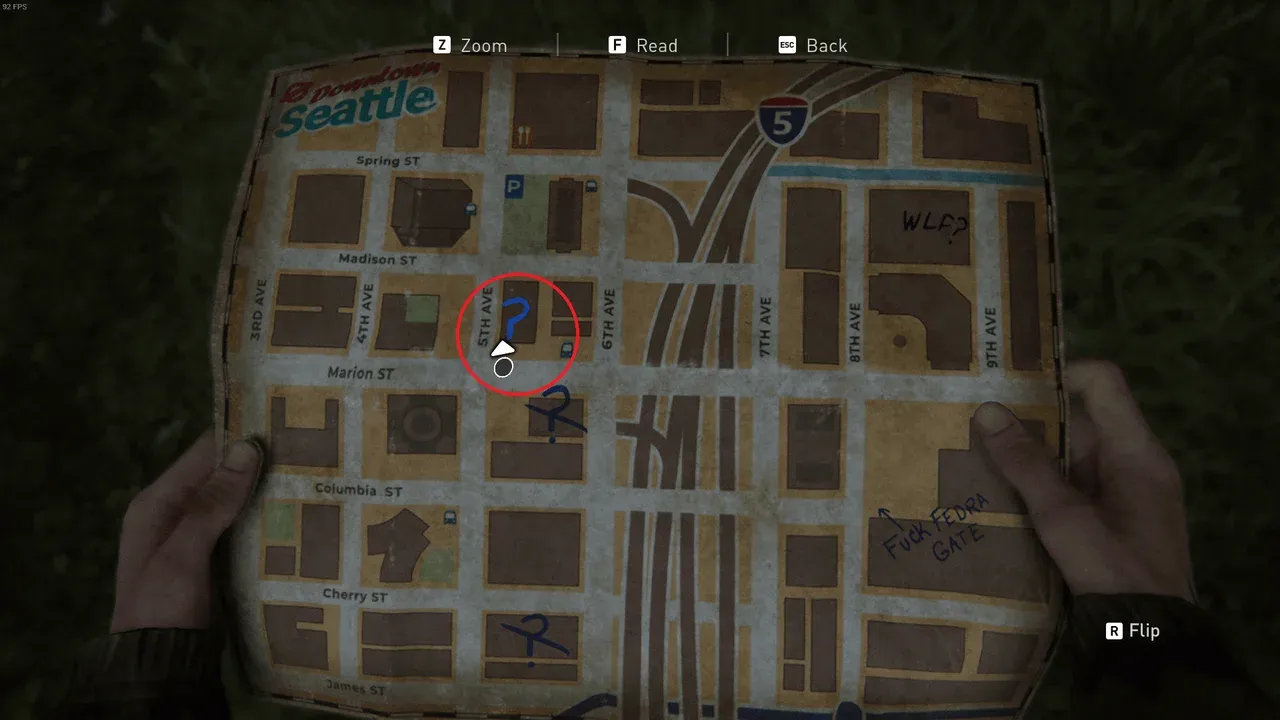 Ellie holds a handwritten map of downtown Seattle marking journal entry locations in The Last of Us Part II.