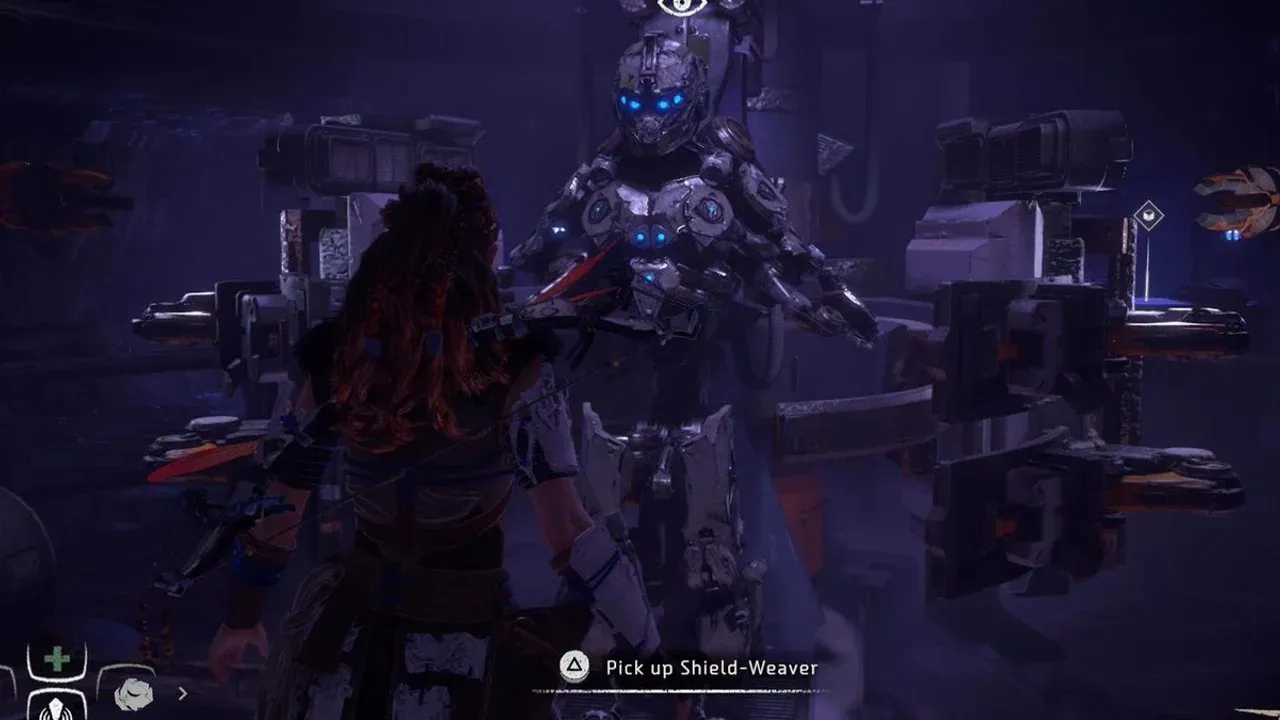 Aloy stands before the glowing Shield-Weaver armor in the Ancient Armory bunker in Horizon Zero Dawn.