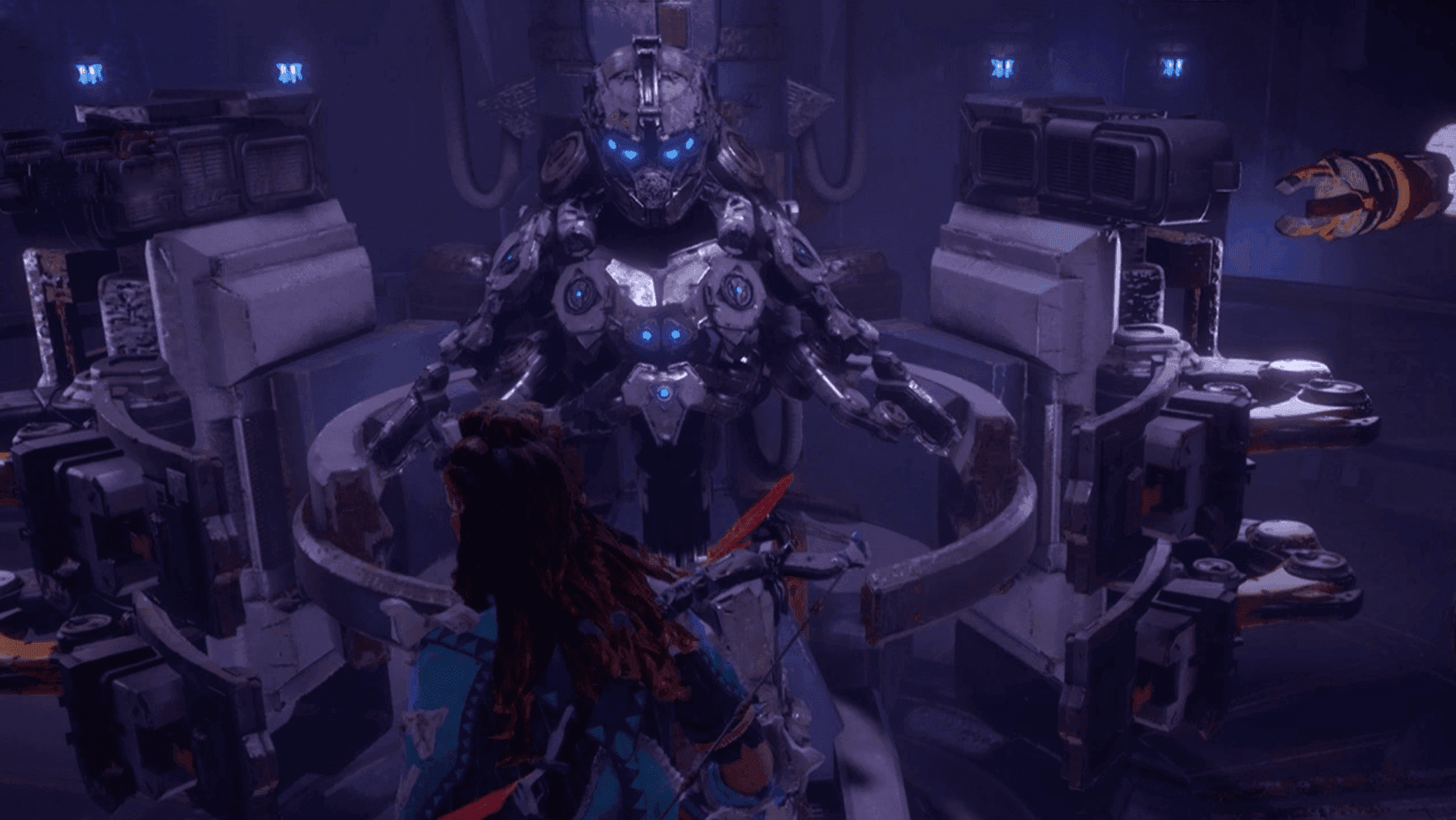 Aloy faces a glowing robotic figure while wearing the Shield-Weaver armor in Horizon Zero Dawn.