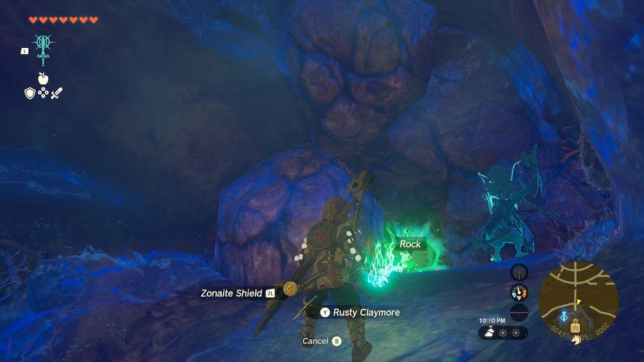 Link uses a rock hammer to destroy boulders and mine ore in Zelda: Tears of the Kingdom.