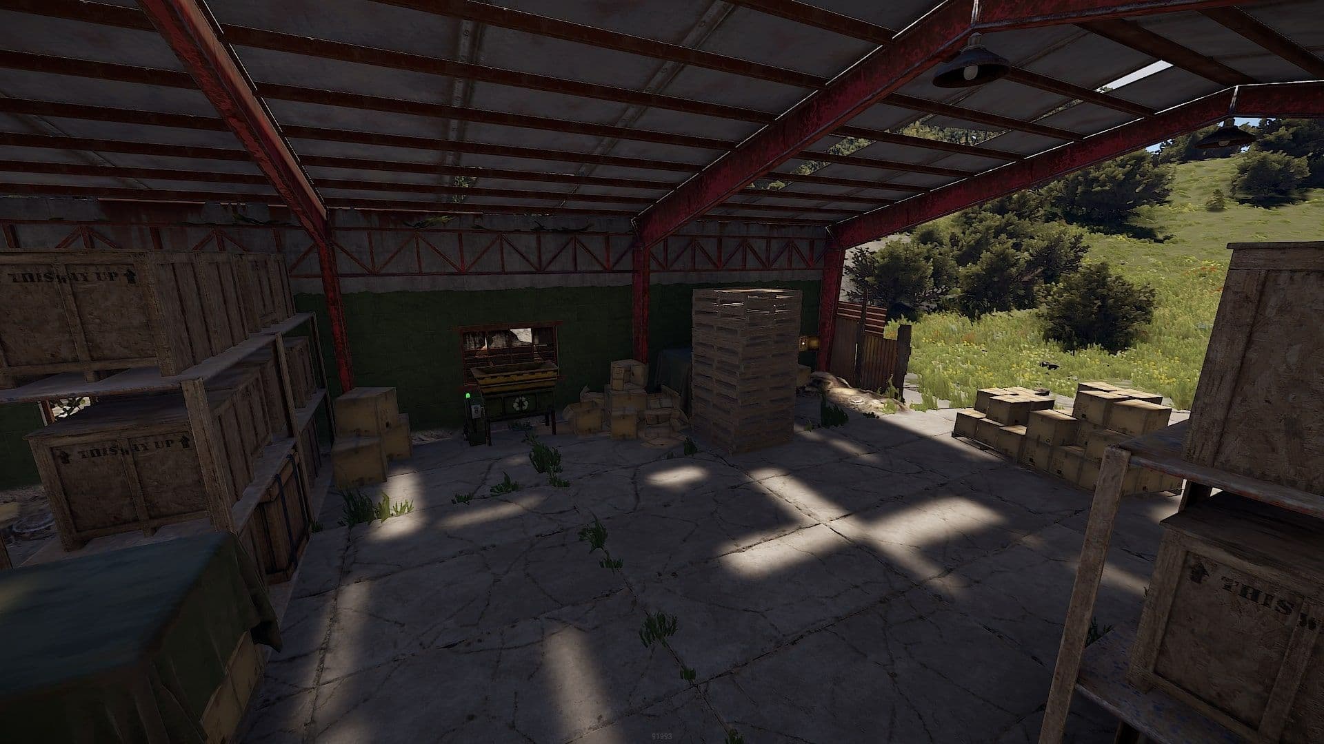 The recycler inside the covered hangar at the Rust Mining Outpost monument, surrounded by wooden loot crates