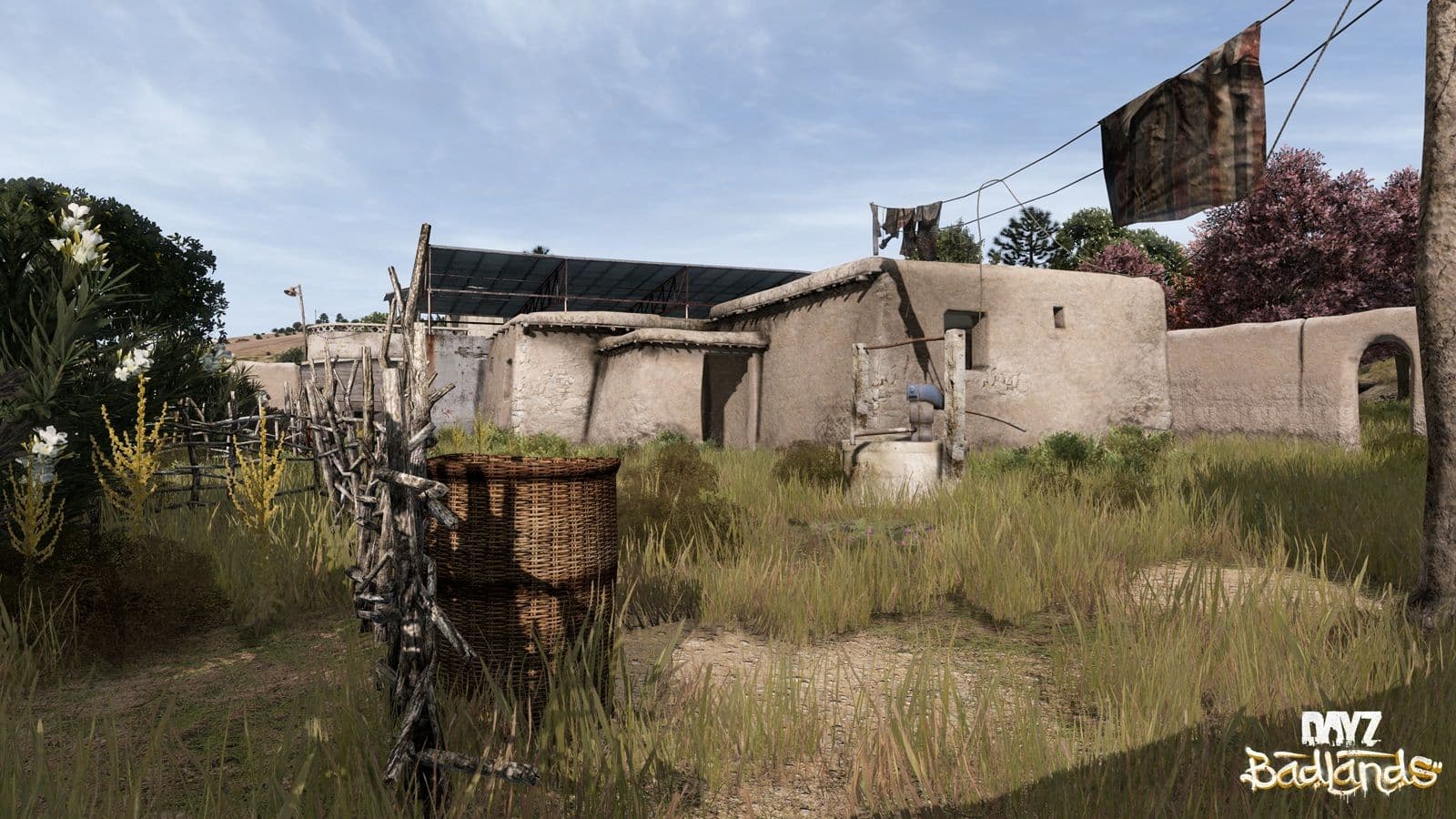 A stone well and hand pump in the courtyard of a mud-walled Nasdara compound in DayZ Badlands