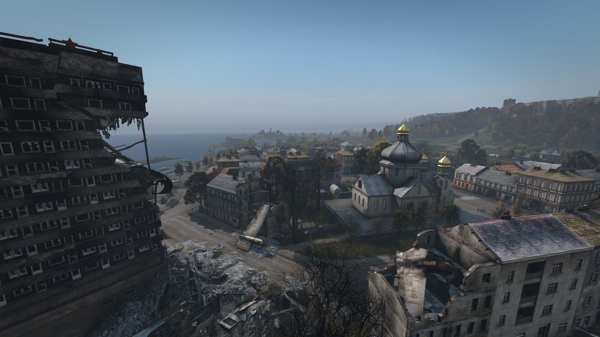 Damaged Chernogorsk skyline with a ruined high-rise, church, and exposed streets
