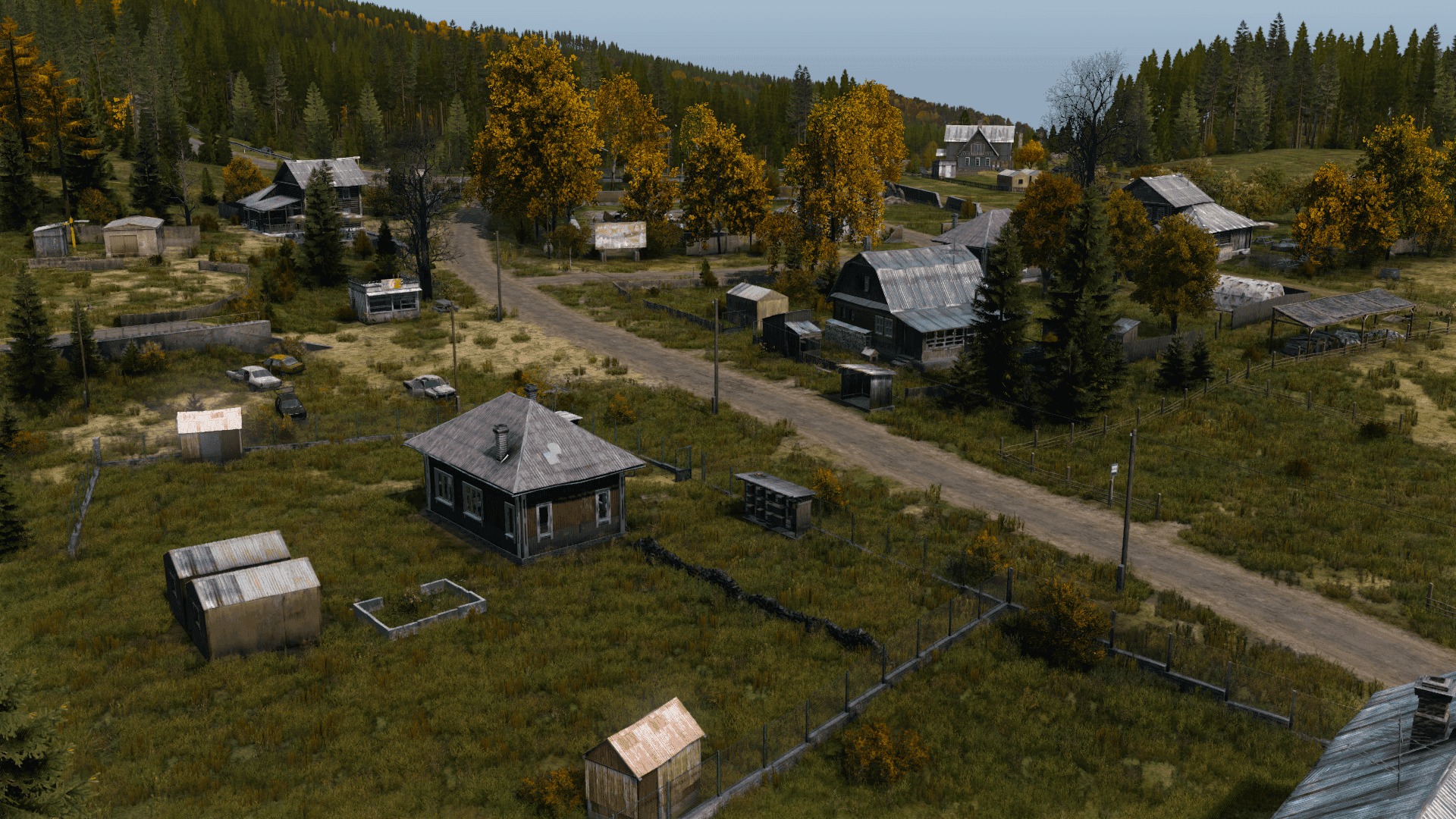 Aerial view of Kamensk's rural roads, homes, and abandoned vehicles in Chernarus