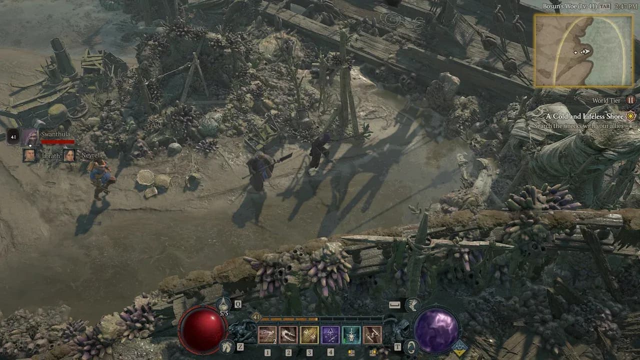 A party of four heroes explores a desolate, wreckage-strewn coastline in the open world of Diablo IV.