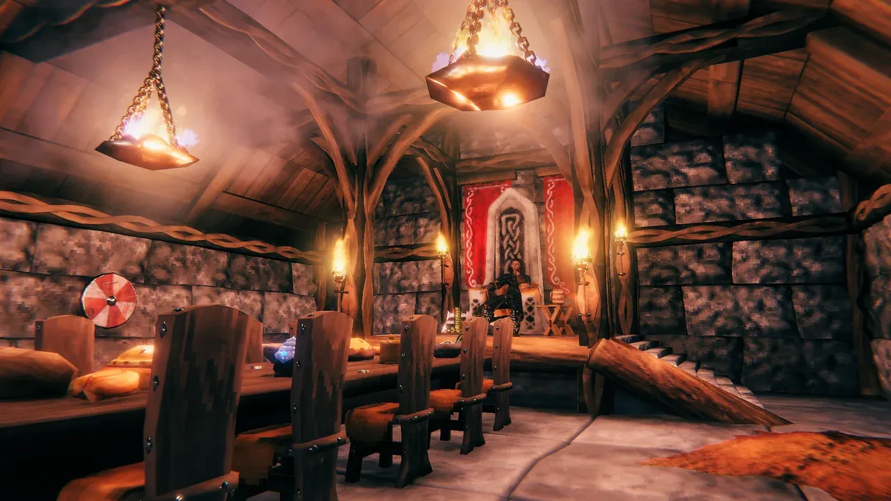Valheim hall with Hearth & Home building pieces, stone walls, wooden beams, shields, and hanging braziers