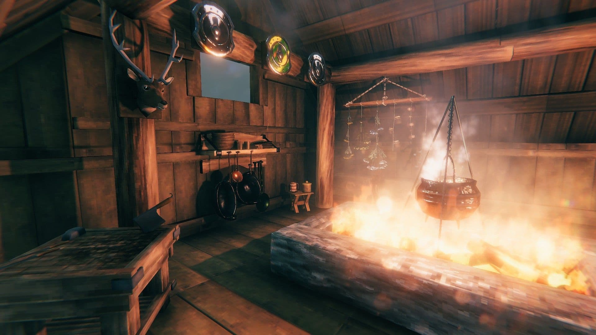 Valheim cooking area with a cauldron, hanging cookware, and Hearth & Home kitchen furnishings