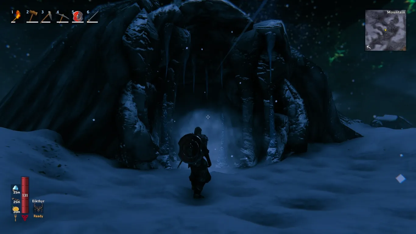 Armored Viking approaching a stone-arched Frost Cave entrance in a snowy Mountain at night