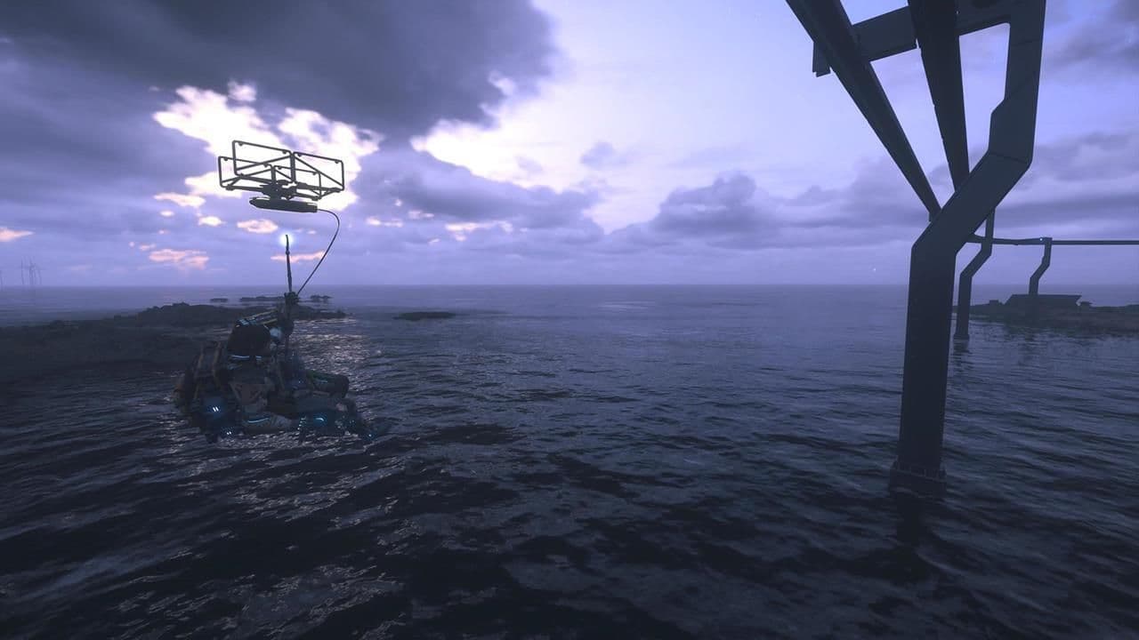 A monorail transport cart hangs from a cable system over water in Death Stranding 2 during dusk.