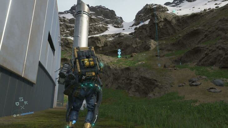 Sam Bridges wearing the All-Terrain Skeleton in Death Stranding while navigating snowy mountain peaks.