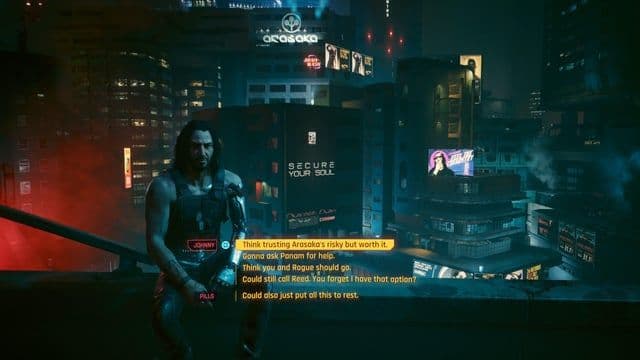 Johnny Silverhand stands on a neon-lit rooftop in Cyberpunk 2077