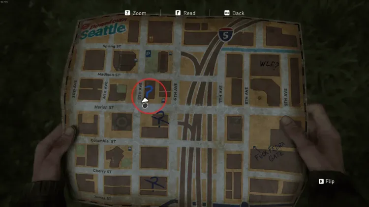 Ellie holds a handwritten map of downtown Seattle marking journal entry locations in The Last of Us Part II.