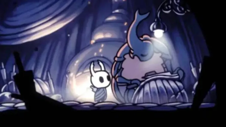 The Knight looks up at the Nailsmith in his City of Tears hut to begin nail upgrades in Hollow Knight.