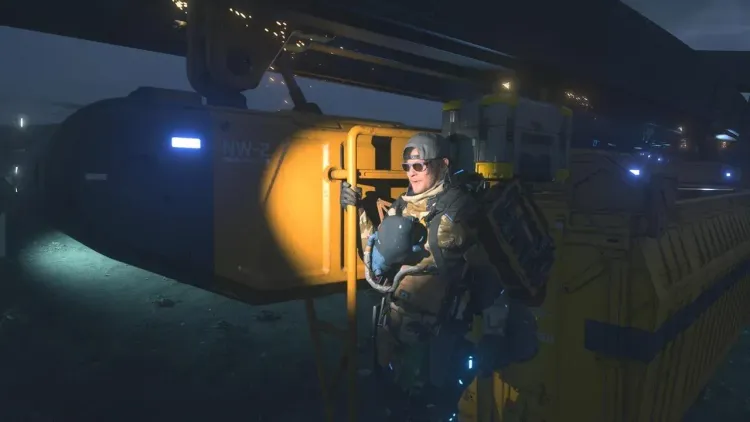 A soldier stands beside a yellow NW-2 monorail vehicle in Death Stranding 2, showcasing the new transport system.