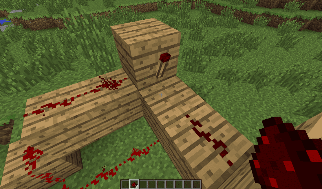 A dimly lit redstone dust wire at the end of a long circuit in Minecraft.