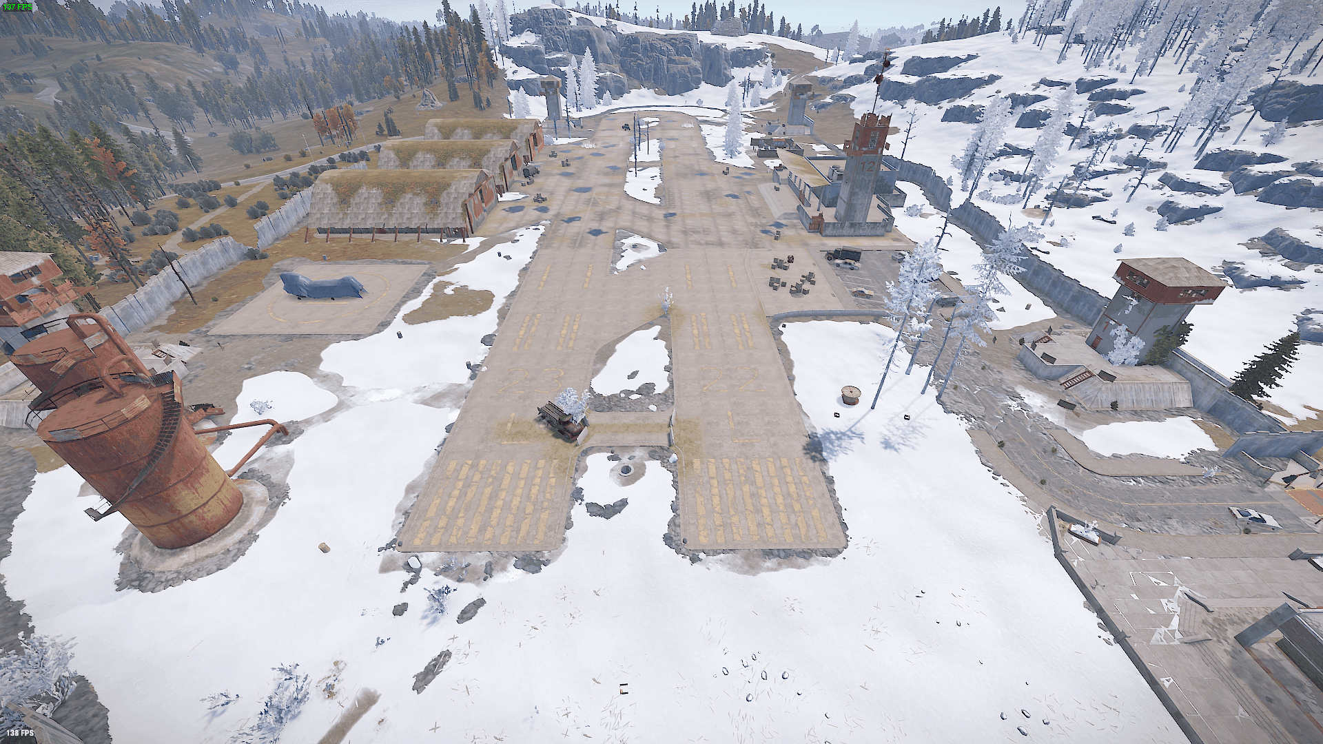 Aerial view of Rust's Airfield showing two runways, three hangars, office tower, and perimeter wall