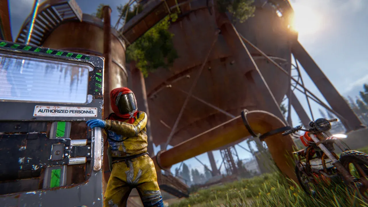 A player in a hazmat suit opens a green card door marked Authorized Personnel at a Rust monument