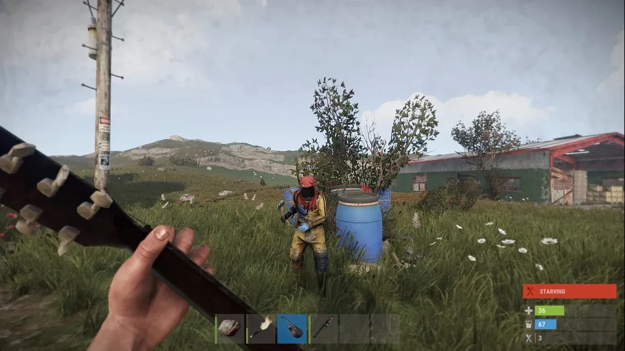 A survivor holds a hammer near a blue barrel in the desolate open world of Rust survival gameplay.