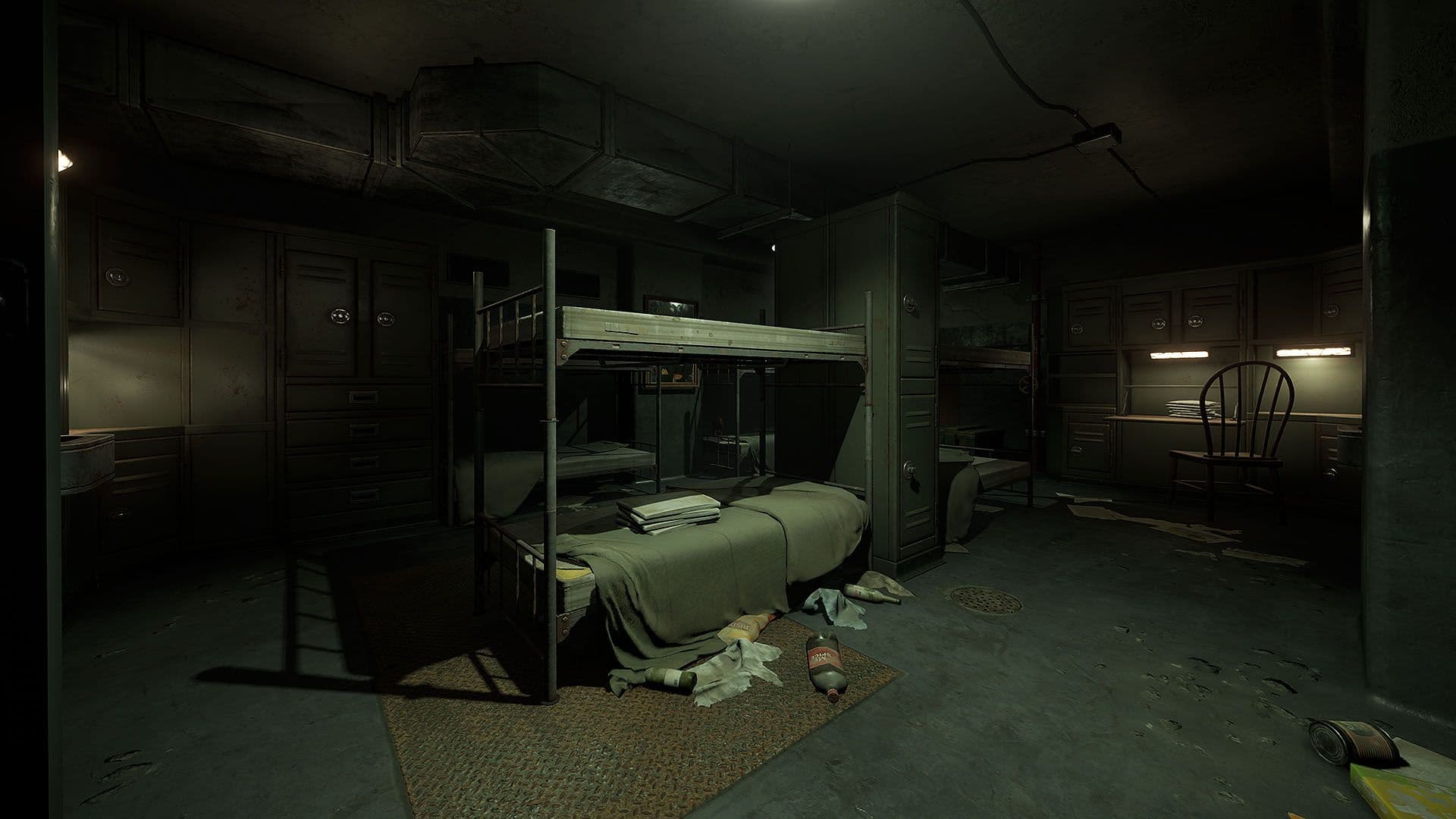 The living quarters inside Rust's Nuclear Missile Silo: bunk beds made up with blankets, folded linen on a mattress, closed lockers, a rug and a floor drain