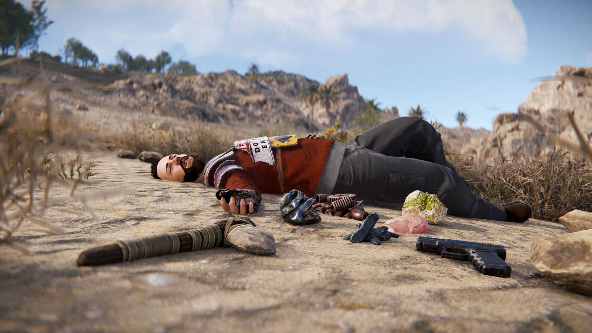 Rust player dead in the desert with dropped loot and a weapon