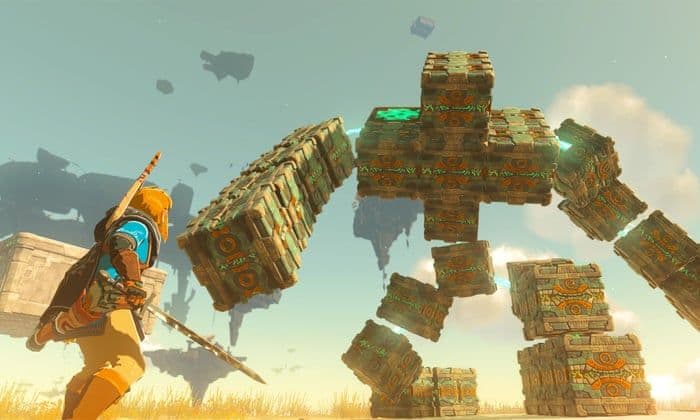 Link battles a massive Flux Construct boss in a field in Tears of the Kingdom.