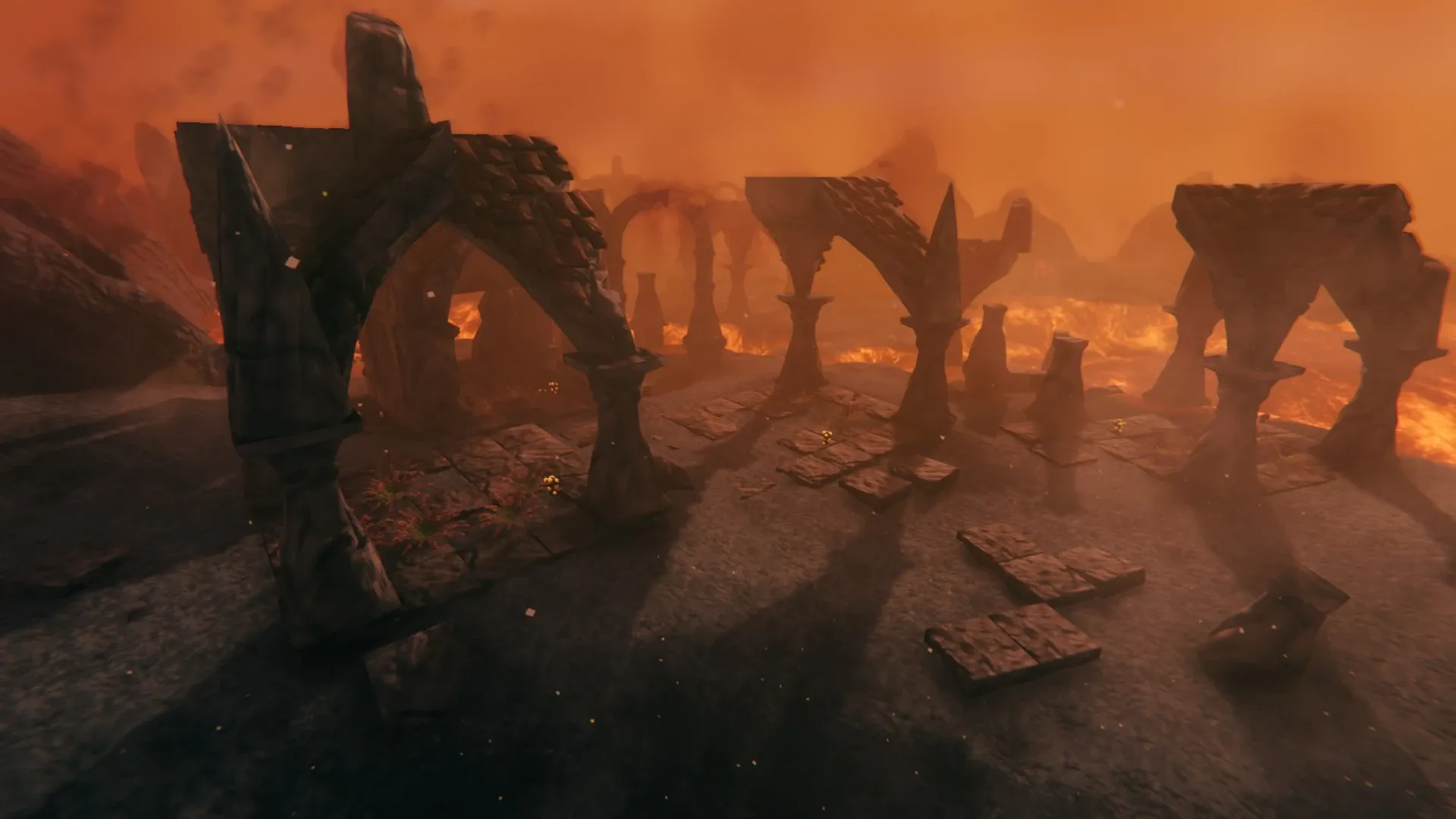 Ruined Grausten arches and paving of a Charred Ruins site in Valheim’s Ashlands, lava burning behind them