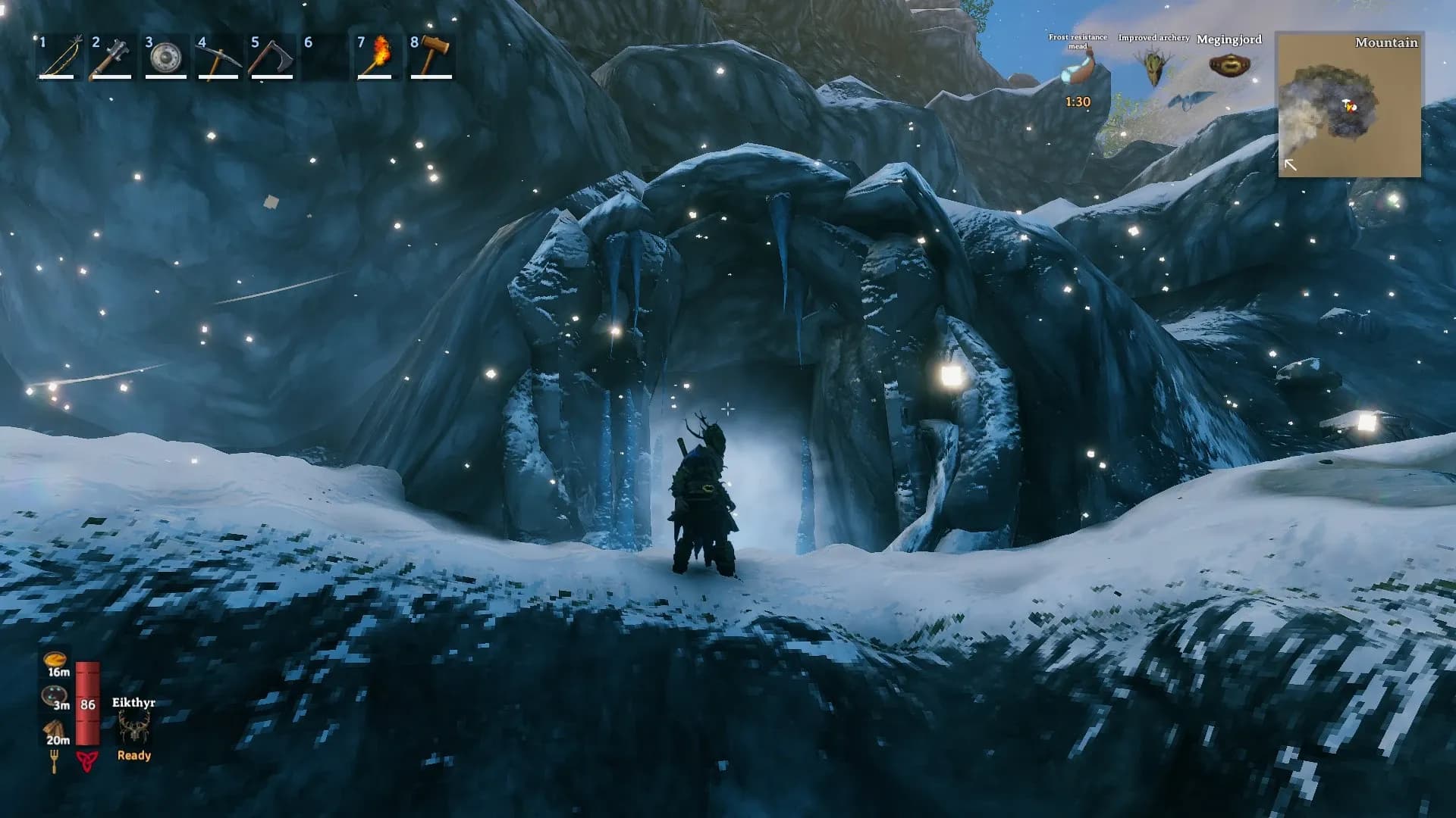 A Valheim Viking standing at a Frost Cave entrance in the Mountains with a frost resistance mead buff active